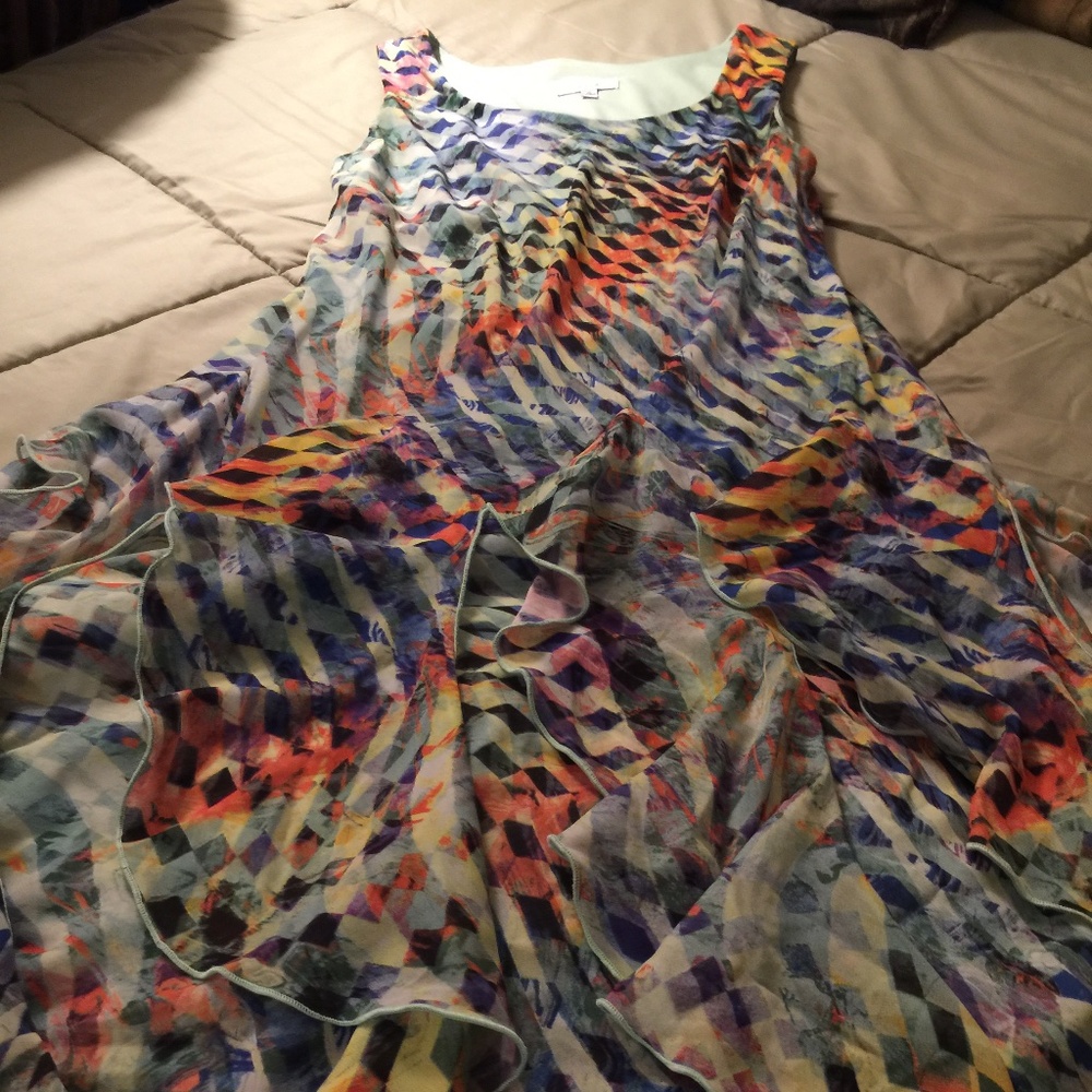 A signature multi color flare dress with cut away design pieces of the dress